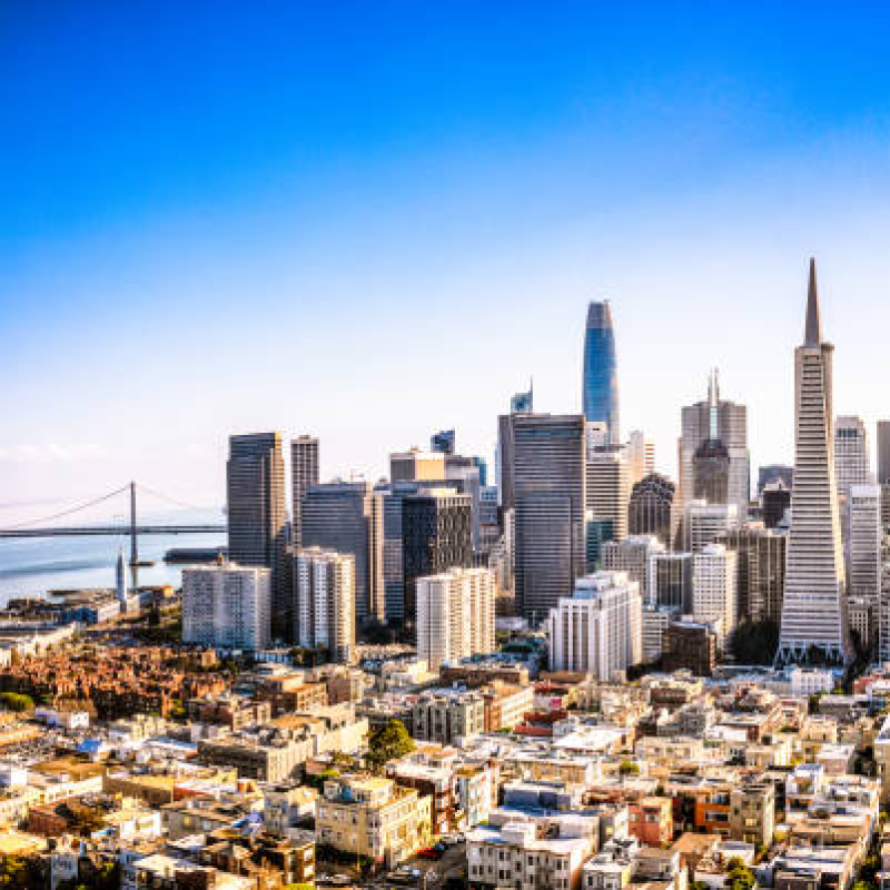A city skyline with a bridge and a body of water

Description automatically generated